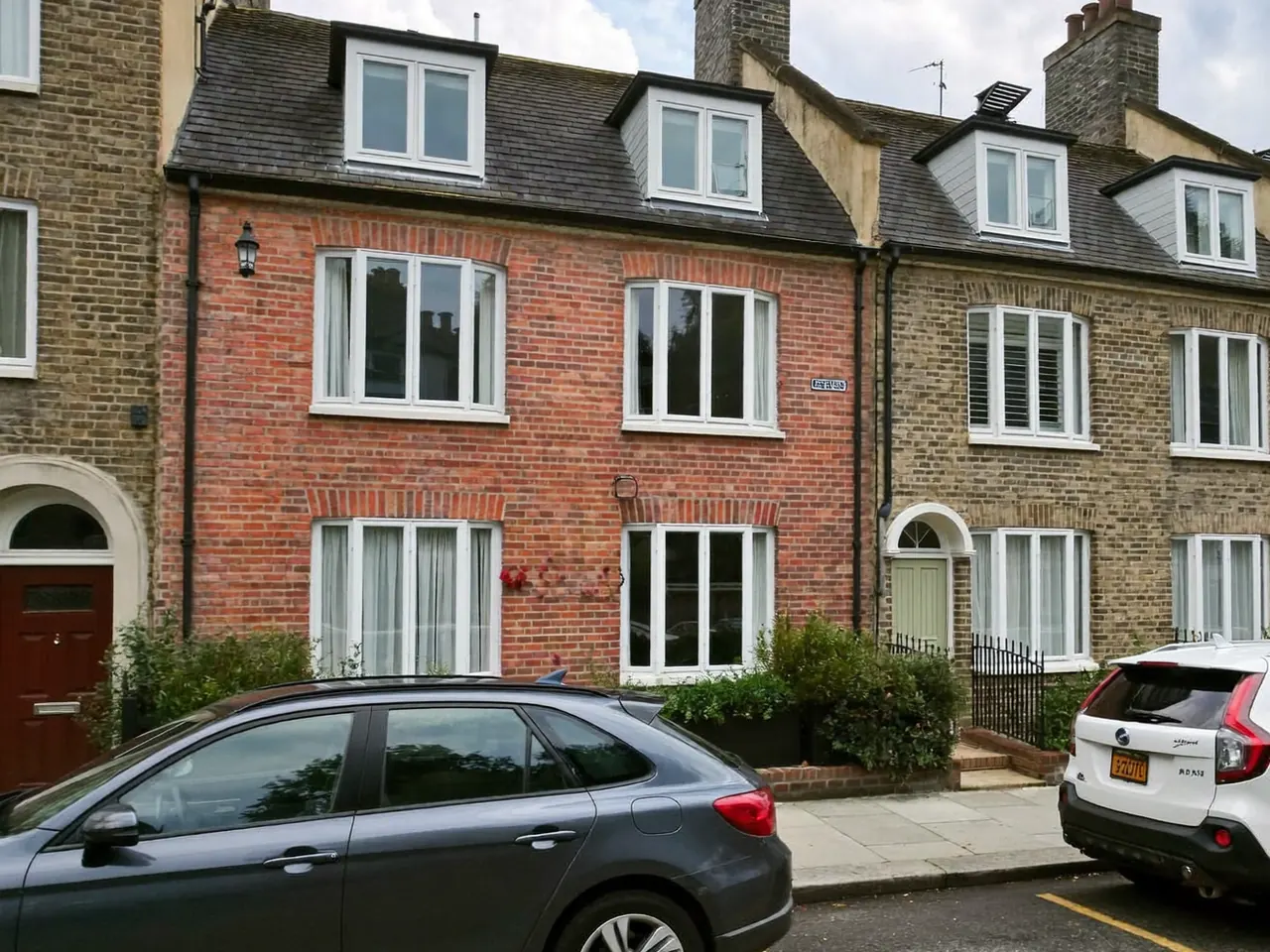 Tall Georgian sash windows on a listed brick building