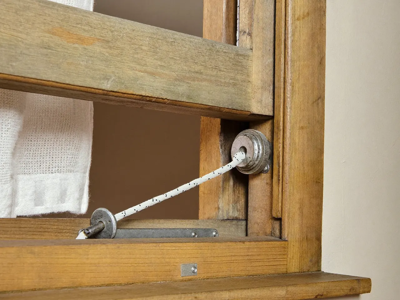 Cutaway of a cord-and-weight sash window mechanism