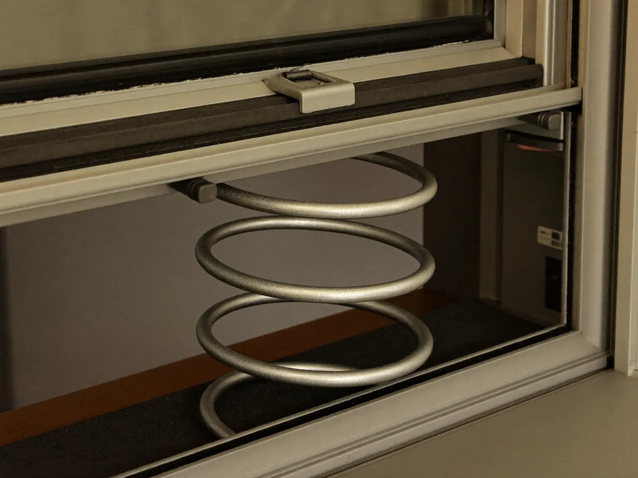 Detail of a spiral balance fitted to a sash window frame