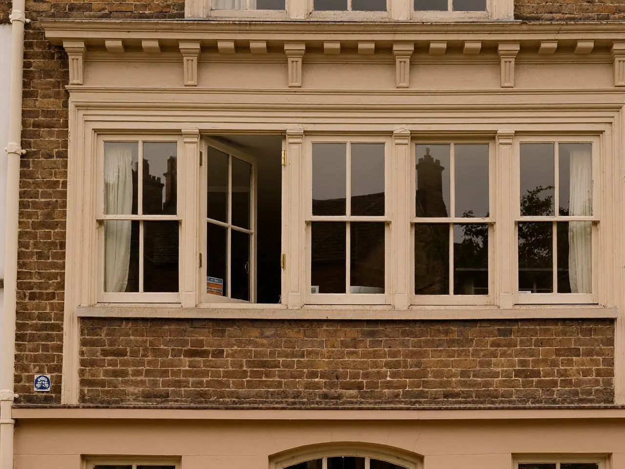 Timber sash windows in a Victorian bay on a brick home