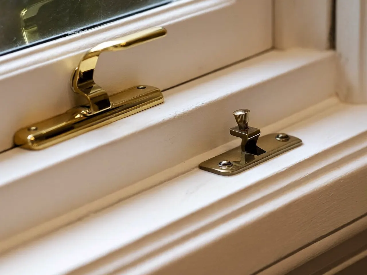 Freshly painted timber sash window with brass fittings